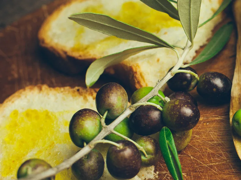 Bottiglie e olive di olio extravergine pugliese Cristofaro