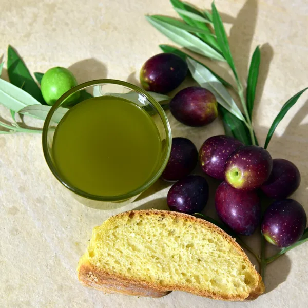 Bottiglia di olio extravergine con velatura naturale, dettaglio del colore torbido dell'olio appena spremuto