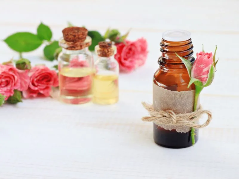 Petali di rosa e olio extravergine di oliva versato in una ciotola, simbolo dell'unione tra i due elisir naturali