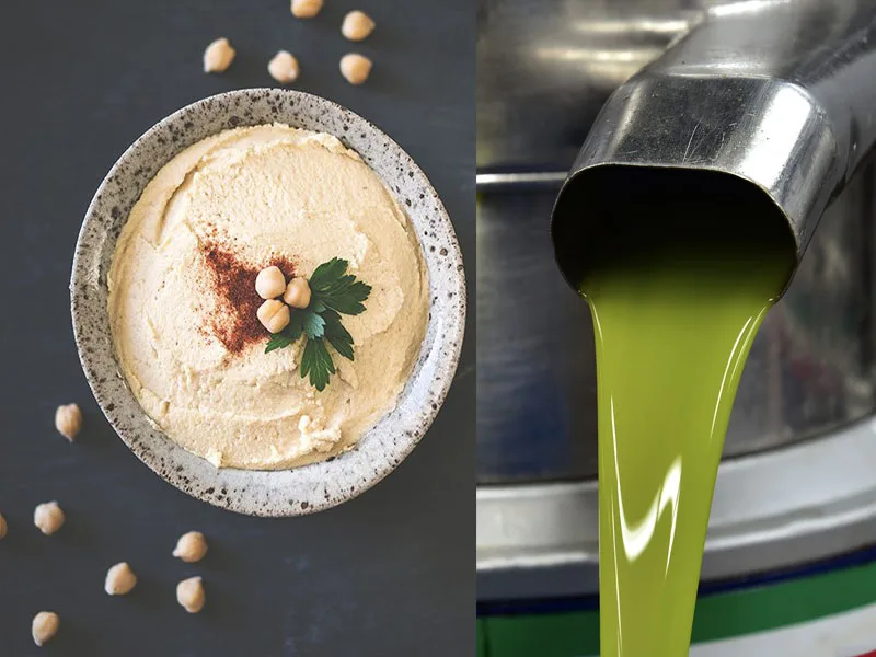 Hummus di ceci cremoso decorato con prezzemolo fresco e un filo di olio extravergine di oliva