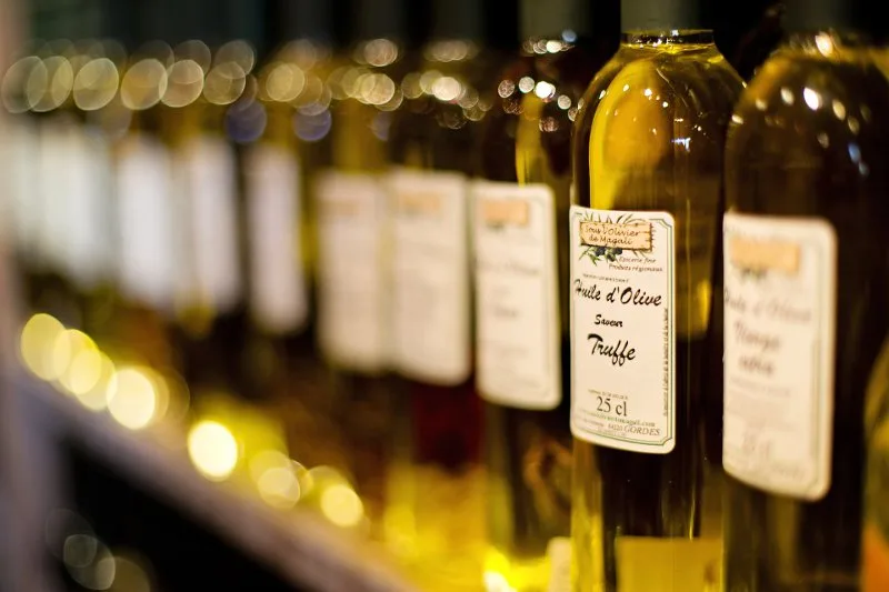 Bottiglia di olio lampante torbido, di scarsa qualità, a confronto con l'olio extravergine